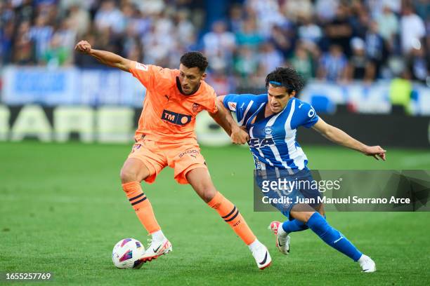 Selim Amallah of Valencia CF duels for the ball with Ianis Hagi of Deportivo Alaves during the LaLiga EA Sports match between Deportivo Alaves and...