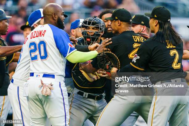 Marcell Ozuna of the Atlanta Braves and Endy Rodriguez and Johan Oviedo of the Pittsburgh Pirates during a benches-clearing brawl in the first inning...