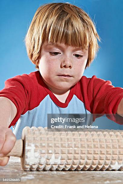 boys rolling out dough with studded pin - freckle arm stock pictures, royalty-free photos & images