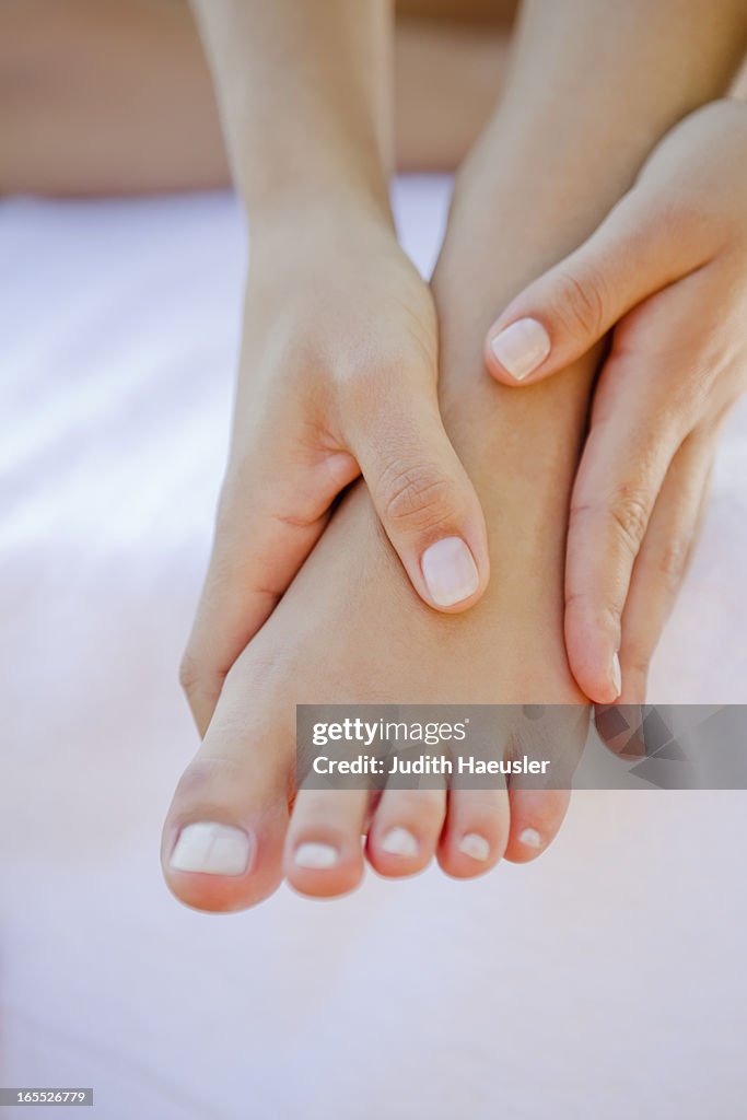 Close up of woman rubbing her foot