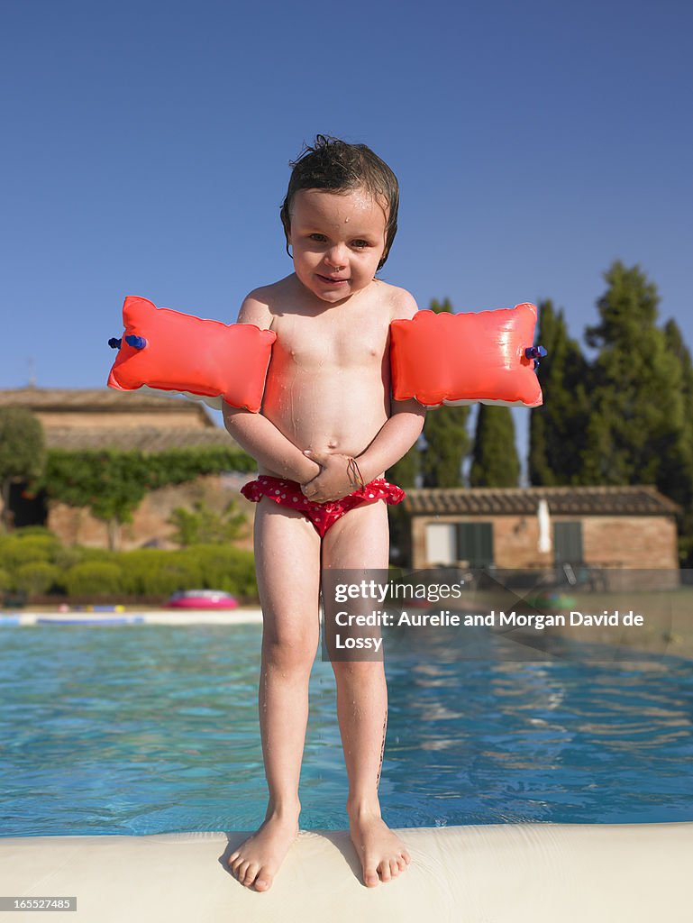 Girl in floaters at swimming pool