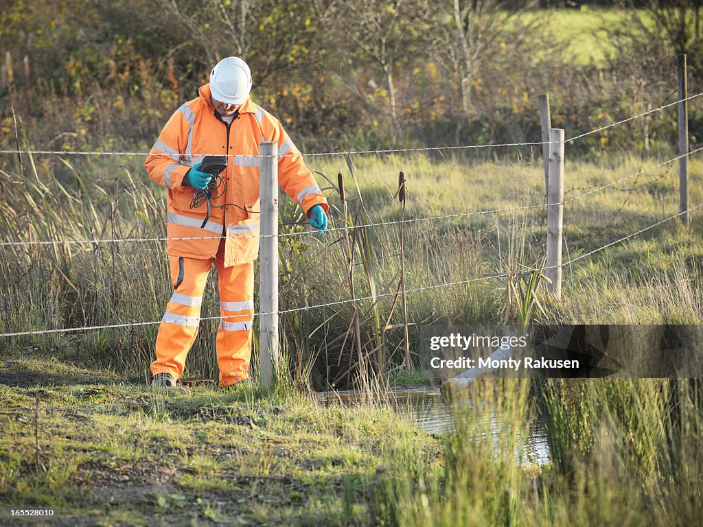 Ecologist monitoring water quality near site of surface coal mine