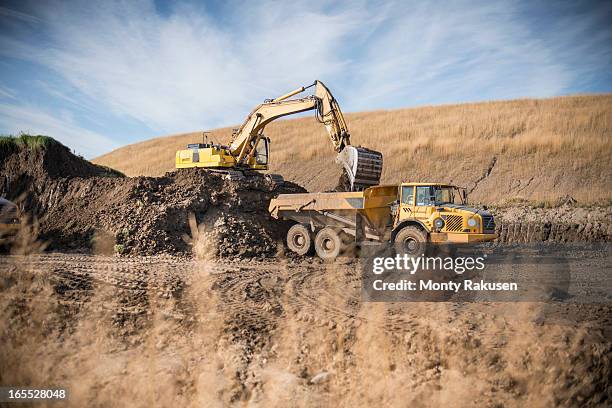 excavator moving top soil at surface coal mine restoration - matjord bildbanksfoton och bilder