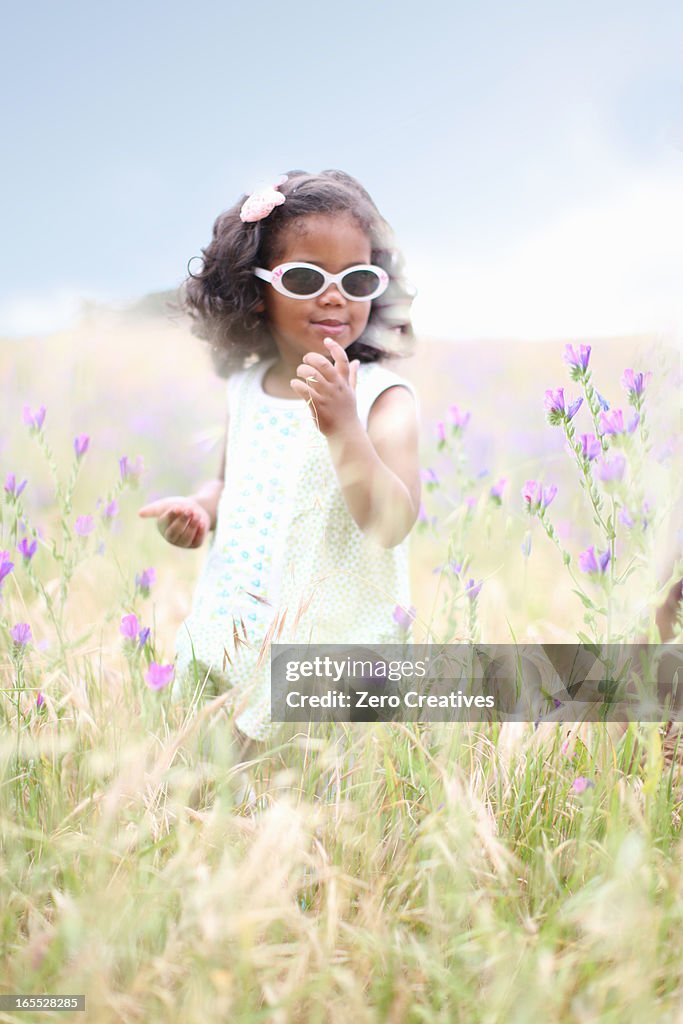 Girl standing in tall grass