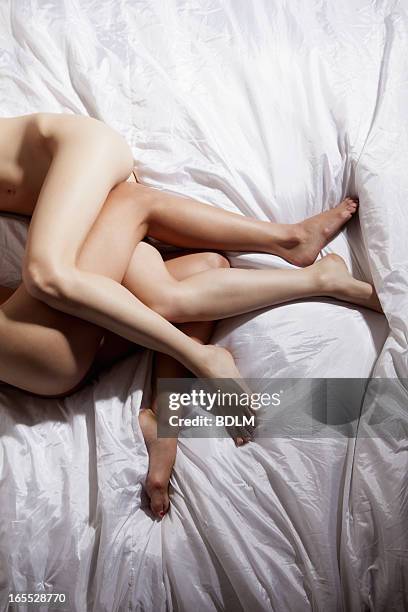 womens naked legs in bed - lesbian bed stock pictures, royalty-free photos & images