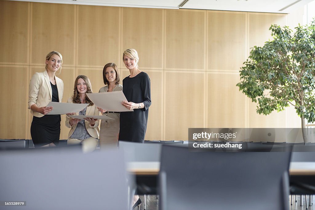 Businesswomen smiling in cafeteria