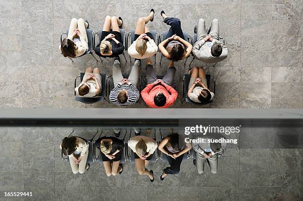 business people sitting in waiting area - people sitting in a row stock pictures, royalty-free photos & images