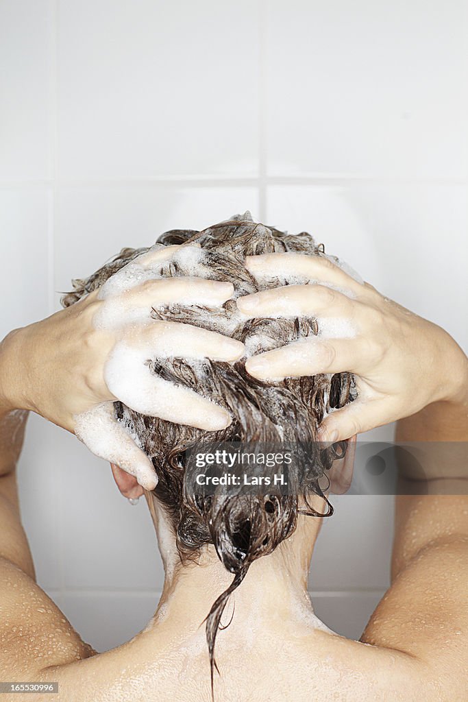 Woman washing her hair in shower