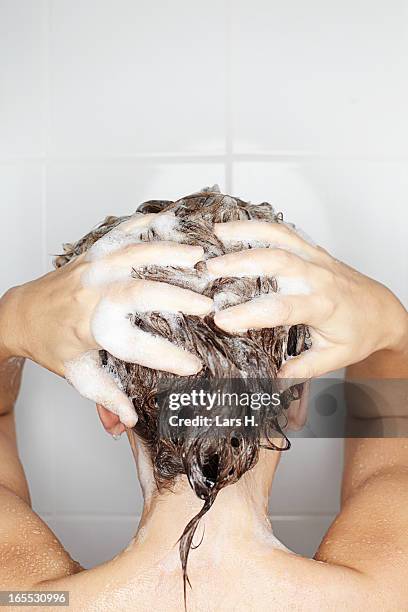 woman washing her hair in shower - wet hair conditioner stock pictures, royalty-free photos & images