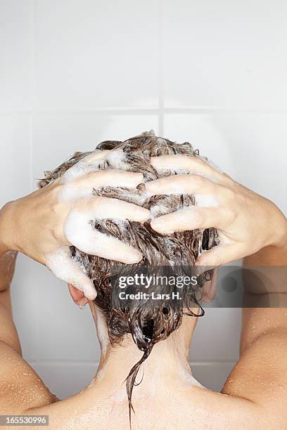 woman washing her hair in shower - wet hair back stock pictures, royalty-free photos & images