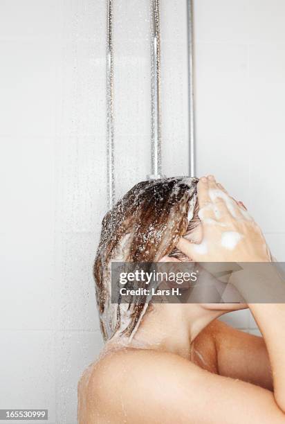 woman washing her hair in shower - wet hair conditioner stock pictures, royalty-free photos & images