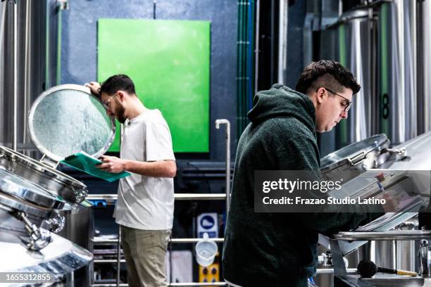 mid adult man annotating something in a beer factory - distillery still stock pictures, royalty-free photos & images