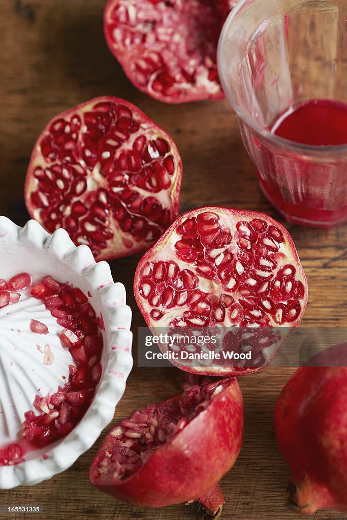 Halved pomegranates with juice