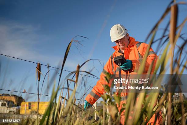 worker monitoring water at surface coal mine - mining low angle foto e immagini stock