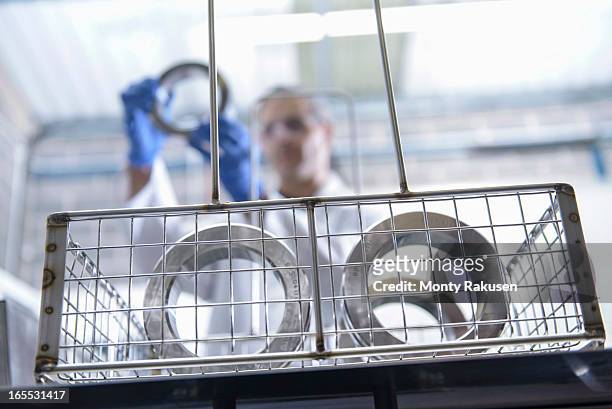 worker cleaning engineering products using ultrasonics, focus on foreground - worker cleaning engineering products using ultrasonics stock pictures, royalty-free photos & images
