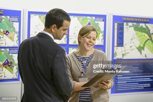 member of public discussing proposed planning inquiry with staff at town hall - city hall stock pictures, royalty-free photos & images