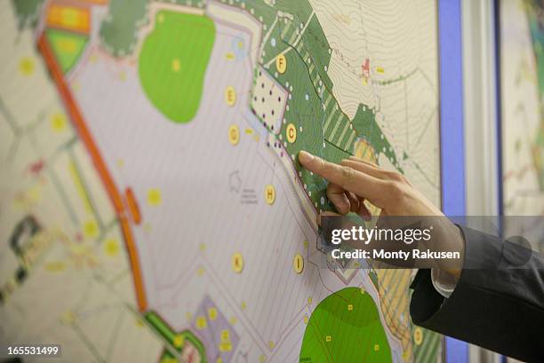 member of public pointing at map of proposed planning inquiry in town hall - town hall uk stock pictures, royalty-free photos & images