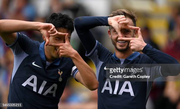 Heung-Min Son of Tottenham Hotspur celebrates with James Maddison after scoring the team's fourth goal during the Premier League match between...