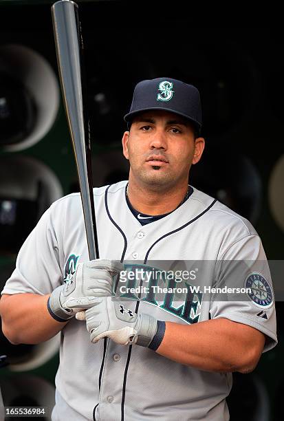 Kendrys Morales of the Seattle Mariners looks on from the dugout against the Oakland Athletics at O.co Coliseum on April 3, 2013 in Oakland,...