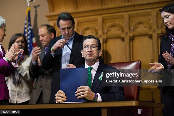 Connecticut Gov. Dannel Malloy looks up after signing a gun-control bill April 4, 2013 in Hartford, Connecticut, After more than 13 hours of debate,...