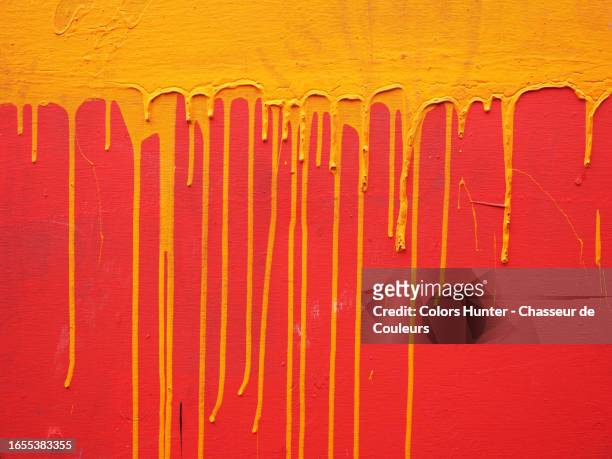 wood panel painted red with orange paint pours in paris, france - fine arts center stock pictures, royalty-free photos & images