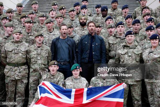 Ahead of a special preview screening Gerard Butler and Aaron Eckhart attend a photocall for 'Olympus Has Fallen' at The Wellington Barracks on April...