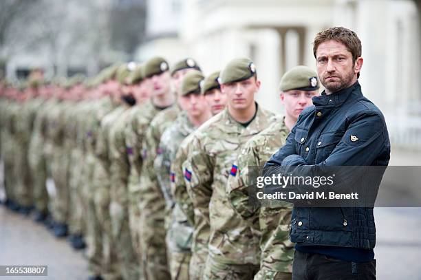 Gerard Butler poses with troops ahead of a special preview screening of Olympus Has Fallen, released in cinemas on April 17, at Wellington Barracks...