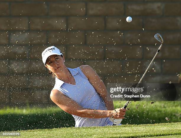 Paige Mackenzie hits out of a bunker on the 15th hole during the first round of the Kraft Nabisco Championship at Mission Hills Country Club on April...