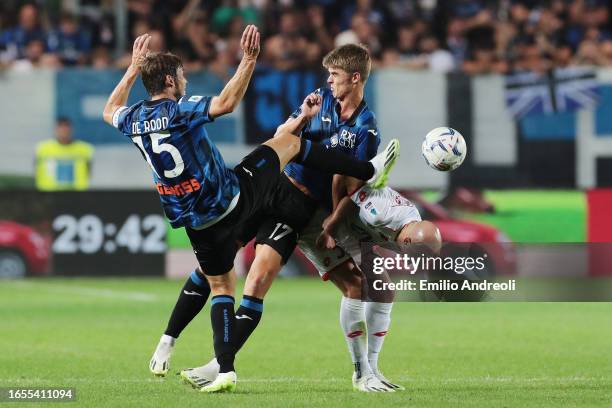 Luca Caldirola of Monza is challenged by Marten de Roon and Charles De Ketelaere of Atalanta during the Serie A TIM match between Atalanta BC and AC...