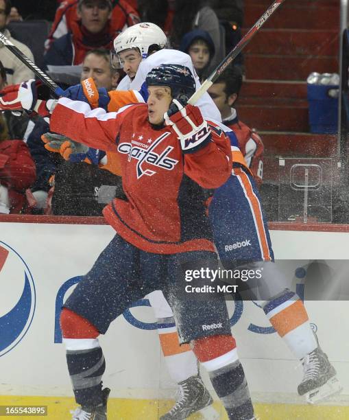 New York Islanders right wing Colin McDonald checks Washington Capitals defenseman Steven Oleksy in the first period at the Verizon Center in...