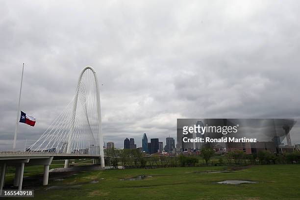 The Texas state flag flies at half staff at the Margaret Hunt Hill Bridge April 4, 2013 in Dallas, Texas. The flag was flown at half staff on the day...
