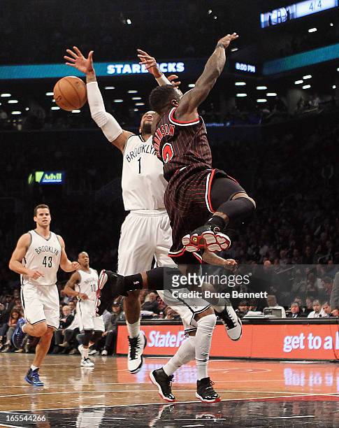 Watson of the Brooklyn Nets and Nate Robinson of the Chicago Bulls collide at the Barclays Center on April 4, 2013 in New York City. NOTE TO USER:...