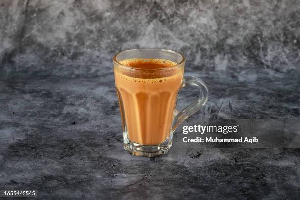 chai served in a glass cup. - chai tea stock pictures, royalty-free photos & images