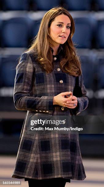 Catherine, Countess of Strathearn watches an athletics demonstration as she and Prince William, Earl of Strathearn visit the Emirates Arena on April...