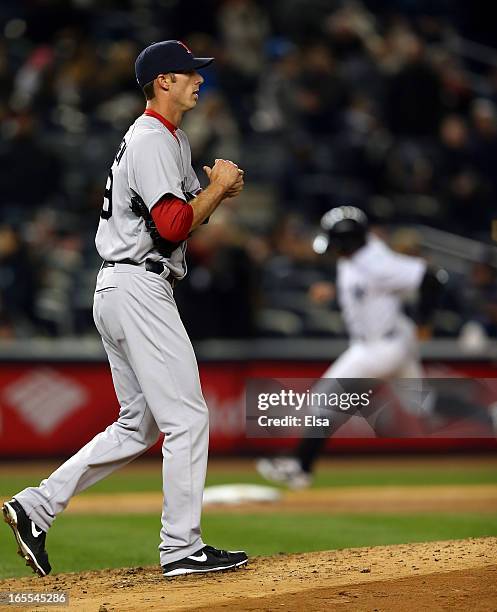 Clayton Mortensen of the Boston Red Sox reacts as Francisco Cervelli of the New York Yankees rounds third base after a solo home run on April 4, 2013...