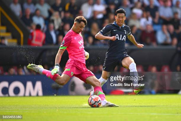 Spurs player Heung-Min Son chases down Burnley goalkeeper James Trafford during the Premier League match between Burnley FC and Tottenham Hotspur at...