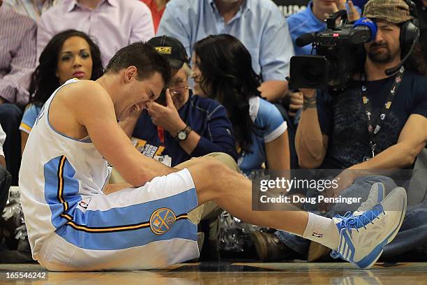 Danilo Gallinari of the Denver Nuggets grimaces as he injures his left leg and was forced to leave the game against the Dallas Mavericks at the Pepsi...