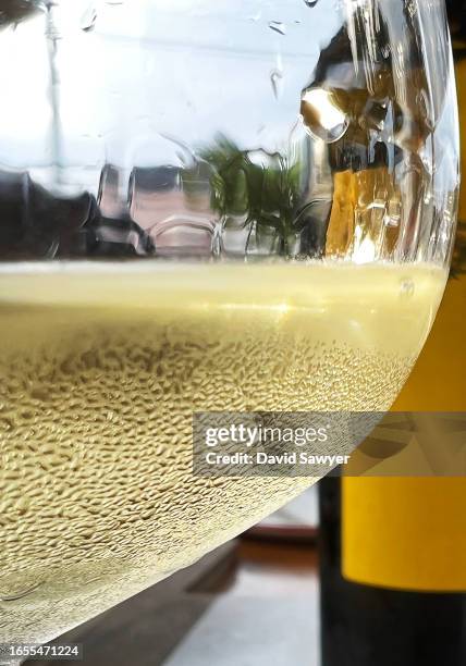 close up of a glass of white wine. - empty glasses after party stock-fotos und bilder