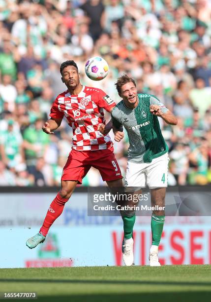 Karim Onisiwo of FSV Mainz 05 and Niklas Stark of Werder Bremen battle for the ball during the Bundesliga match between SV Werder Bremen and 1. FSV...