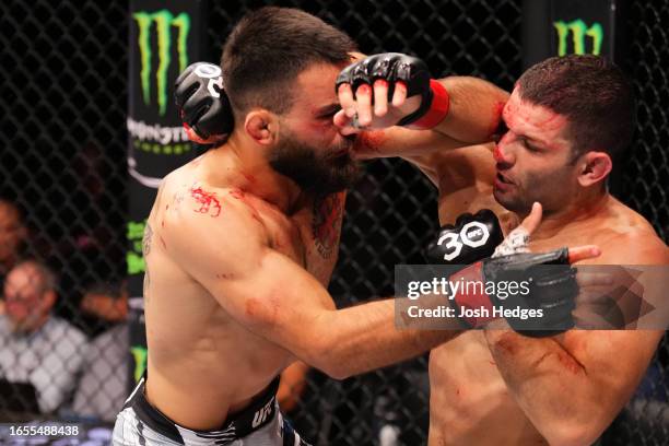 Benoit Saint Denis of France elbows Thiago Moises of Brazil in a lightweight fight during the UFC Fight Night event at The Accor Arena on September...