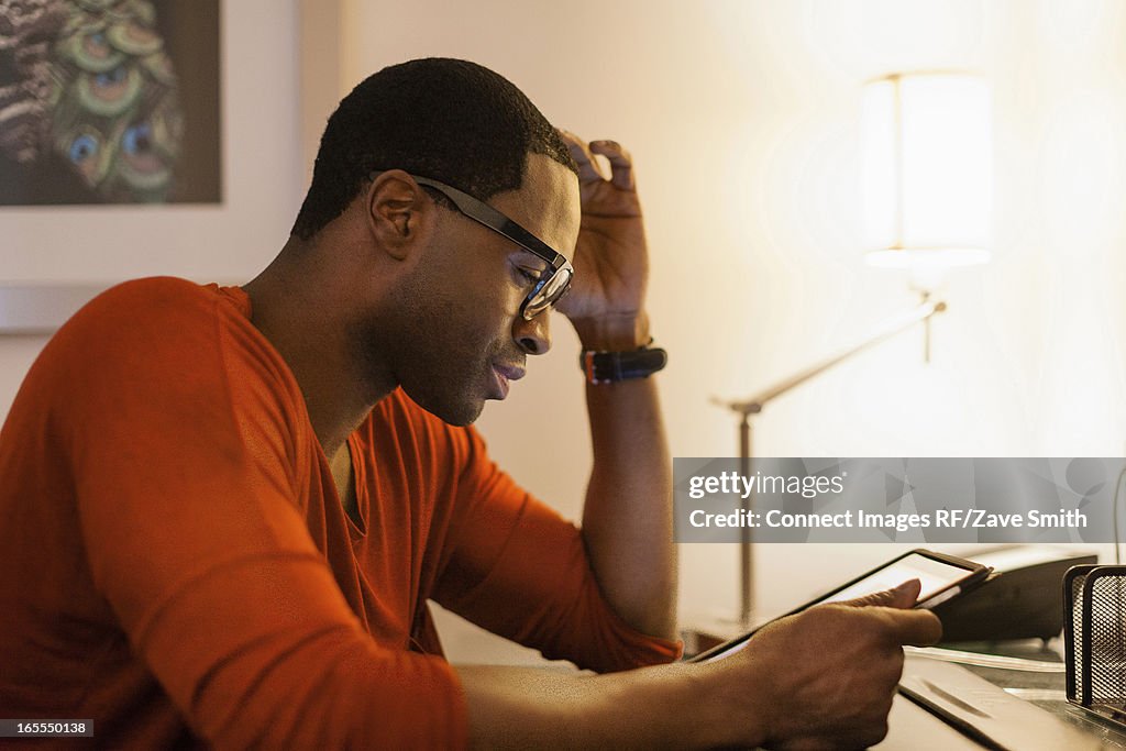 Man using tablet computer at desk