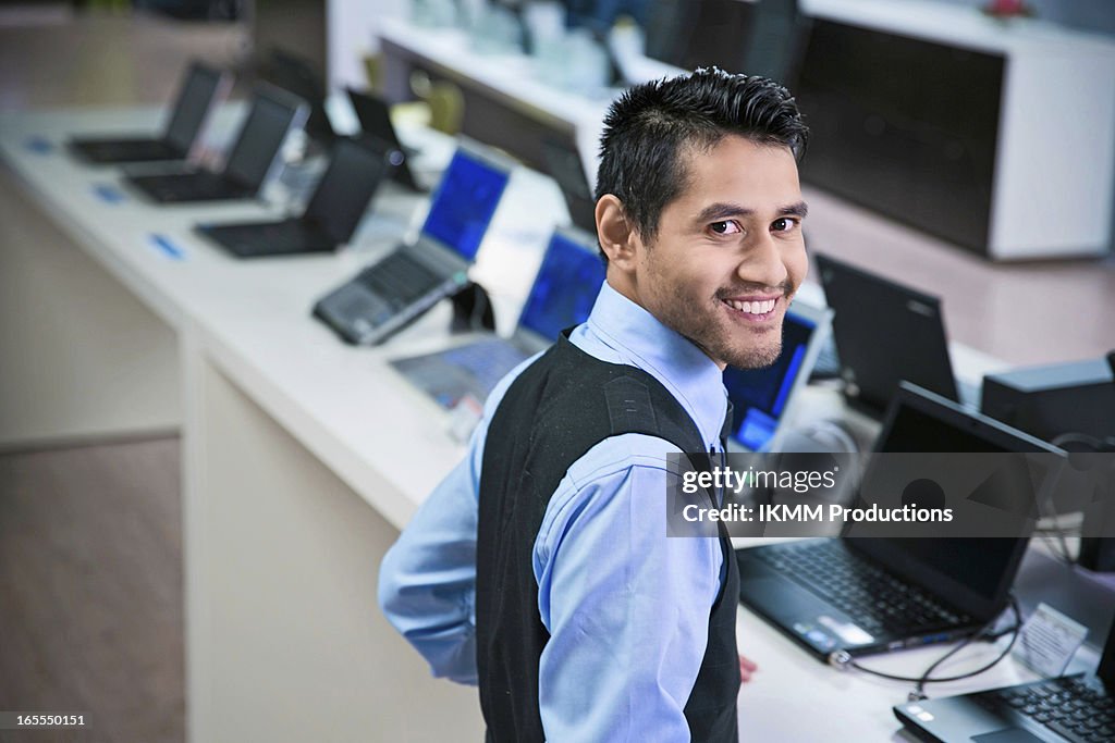 Salesman smiling in store