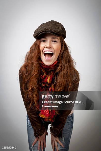 laughing woman leaning on knees - beret cap stock pictures, royalty-free photos & images