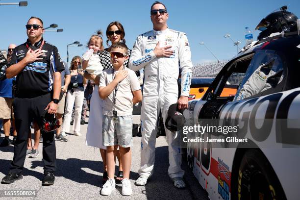 Kyle Busch, driver of the LA Golf Chevrolet, stands on the grid with his wife, Samantha Busch, daughter, Lennix Busch and son, Brexton Busch on the...