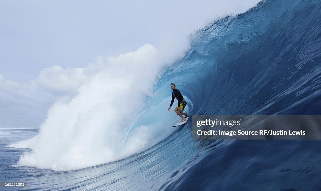 Man surfing in curl of wave