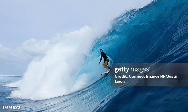 man surfing in curl of wave - surfer wave stock pictures, royalty-free photos & images