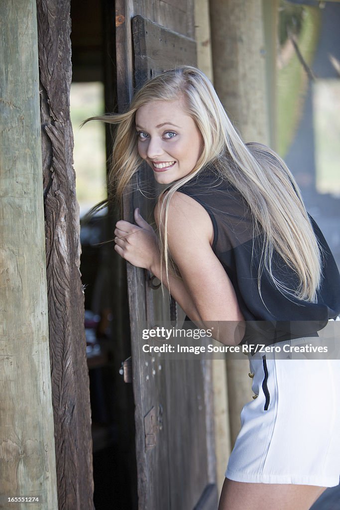 Smiling woman opening door