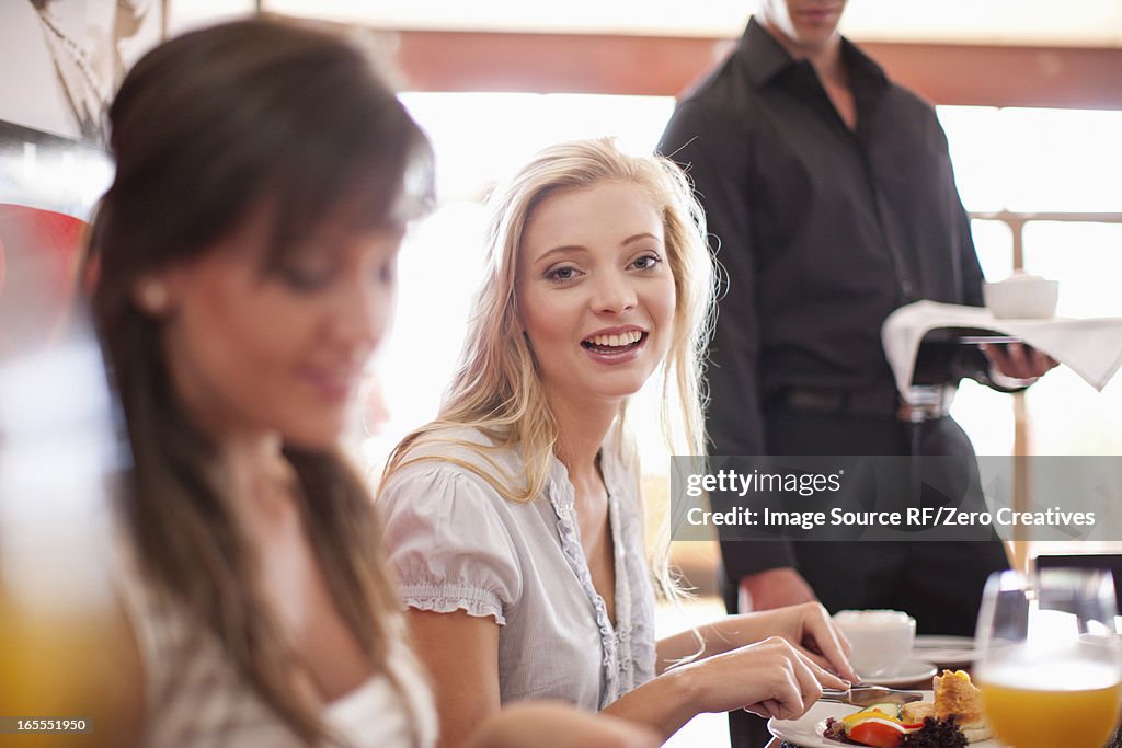 Women having breakfast together in cafe