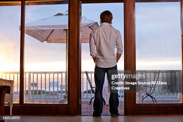 man standing in doorway of patio - travel african sunset rf photos only stock pictures, royalty-free photos & images