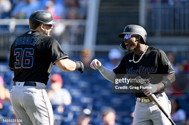 Jake Burger of the Miami Marlins celebrates with Jazz Chisholm Jr. #2 after hitting a home run in the first inning against the Washington Nationals...